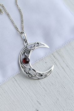 ITEM DESCRIPTION: The size of this circle pendant H 4 cm x W 3 cm. Weight - 4g. You can buy this necklace with a chain or without and with different stones. Jewelry will come to you in a gift box - ready for gift giving. I made this moon necklace of sterling silver, red garnet, and tiny labradorite. I think this color combination is very elegant and luxurious! The parcel will be sent 1-2 days after payment. Delivery usually takes 10-21 days. But in the period from December to February this may t Spiritual Moon Phase Pendant Jewelry, Celestial Necklace With Large Round Pendant, Celestial Style Necklace With Large Round Pendant, Spiritual Moon Shaped Coin Pendant Jewelry, Elegant Moon Phase Round Pendant Jewelry, Elegant Round Pendant Jewelry With Moon Phase, Elegant Round Pendant With Moon Phase Jewelry, Celestial Sterling Silver Round Pendant Jewelry, Celestial Crescent Jewelry With Birthstone