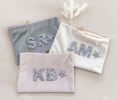 three personalized pouches with sequins on them