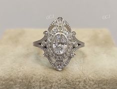 an antique style diamond engagement ring with filigrees