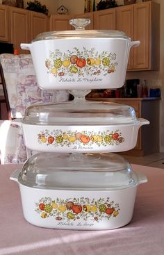 three casserole dishes stacked on top of each other in front of a kitchen counter