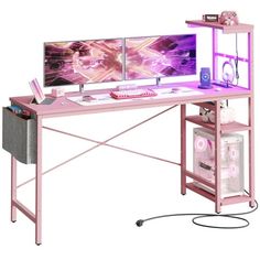 a pink computer desk with two monitors on it