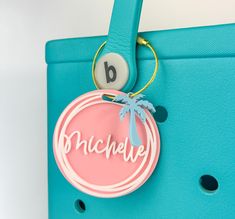 Customize your beach bag or Bogg bag with these cute tags that feature your name or initial in your choice of color. You can also add an optional summer-themed charm to your tag to make it even more festive for the summer season. Get one for yourself, and they also make great gifts -- especially for those who can't get enough Bogg bag accessories!  Just scroll through the listing photos to find all the colors and charm options. HIGHLIGHTS * Comes with a nylon coated metal keychain cable that you can screw/unscrew and easily attach to your bag. * These personalized beach bag tags are made of durable acrylic. * Versatile! You can also use them as a keychain, luggage tag, diaper bag tag, or rearview mirror charm. * Bag tags are approximately 3-inches wide. * Matte finish on front. HOW TO ORDE Personalized Pink Bag For The Beach, Personalized Pink Beach Bag, Personalized Beach Bags, Custom Beach Bags, Rear View Mirror Charm, Travel Luggage Tag, Metal Keychain, Bag Tags, Travel Luggage