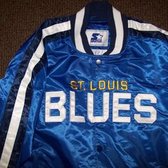 New W Tags Nhl St. Louis Blues Starter Jacket. High Quality Polyester Satin Jacket With A Snap Up Front And Ribbed Knitted Cuffs, Collar And Waist Band. The Jacket Has A Polyester Outer Shell And The Inside Lining Is Soft Polyester. The St. Louis Blues Lettering Blues Logo Meticulously Sewn On. New Starter 2019. Color: Blue With White Sewn On Lettering And Yellow & White Trim. Satisfaction Guaranteed Or Return. Measurements: L: 25" Xl 26" 2x: 28" Across Chest. Blue Collegiate Varsity Jacket For Sports, Collegiate Blue Varsity Jacket For Sports, Blue Casual Varsity Jacket For Sports Events, Blue Collegiate Varsity Jacket For Sports Events, Blue Collegiate Style Varsity Jacket For Sports Events, Blue Varsity Track Jacket For Sports Events, Varsity Blue Track Jacket For Sports Events, Blue Collegiate Track Jacket For Sports Events, Blue Varsity Jacket For Sports Events