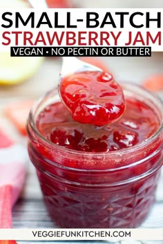 small batch strawberry jam in a glass jar with a spoon sticking out of the top