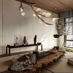 a living room filled with furniture and a tree branch hanging over the top of it