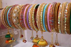 Bangles is an Indian artistic handcraft brand set out to create mesmerizing designs that people would desire to keep and treasure. Every woman is a balance of Beauty, Power & Elegance and we at Bangles aspire to compliment & showcase this Balance. Indian Beauty resides in vibrant colors and soothing elegance, two things that traditionally don't mix together. Elegance demands tranquility while Vibrancy demands energy. 26 Bangles Multicolor Silk Thread Bracelets For Gifts, Multicolor Silk Thread Bracelets As Gift, Multicolor Silk Thread Bangle For Festivals, Multicolor Silk Thread Bangle As Gift, Festive Multicolor Silk Thread Bracelets, Traditional Multicolor Silk Thread Bracelets, Festive Multicolor Handwork Bangle, Silk Thread Bangle Bracelets For Festivals, Traditional Thread Bracelets For Festivals