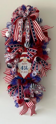 a red, white and blue fourth of july wreath