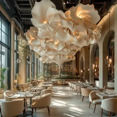 a restaurant with large chandeliers hanging from the ceiling and tables set up for dinner