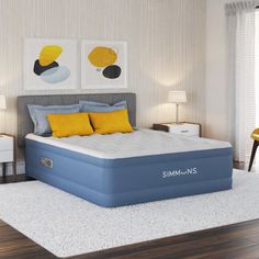 an inflatable mattress sits on the floor next to a night stand and nightstand