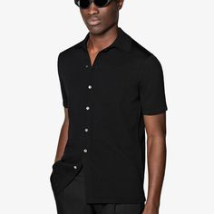 A perfect way to elevate any casual look, this black short-sleeve polo cardigan features a classic polo collar, a seven-button closure, and a slim, tapered silhouette for a sleek aesthetic. Fitted Polo Shirt With Buttons, Fitted Polo Shirt With Collared Neckline, Fitted Collared Polo Shirt With Buttons, Formal Fitted Polo Shirt With Placket, Fitted Polo Shirt With Button Closure For Business Casual, Fitted Button-up Polo Shirt For Business Casual, Fitted Button-up Polo Shirt, Formal Summer Polo Shirt, Formal Summer Collared Polo Shirt