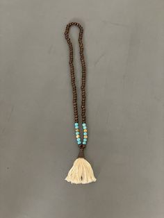 "Prayer beads, mala beads necklace | Vintage Buddha Beaded Tassle Necklace | Meditation Yoga Jewelry | Unisex  Dark wood beads mixed with turquoise dyed howlite and picture jasper beads  Off white thread set in copper  All beads are 8mm  32\" fringe pendant is 3\" long  Check out my shop for more vintage jewelry and clothing! https://sierramadrevintage.etsy.com" Wooden Beads Amulet Necklace For Meditation, Meditation Amulet Necklace With Wooden Beads, Bohemian Wooden Beads Mala For Festival, Bohemian Festival Mala With Wooden Beads, Bohemian Brown Mala As Gift, Bohemian Style Brown Mala For Gift, Bohemian Style Brown Mala As Gift, Spiritual Large Beaded Necklaces For Beach, Festival Wooden Beads In Turquoise