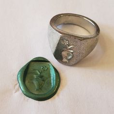 This signet ring is cast in lead-free pewter. The ring size when cast is 7.25. The sealing image is a flower in a vase.       This is part of a series of signet rings I am making cast from lead-free pewter. Each master ring is hand sculpted to give a unique, rustic style, multi-dimensional relief image when used as a stamp to seal, with sealing wax. Vintage Hand Cast Sterling Silver Signet Ring, Vintage Hand Cast Signet Ring As Gift, Antique Hand-cast Signet Ring For Gift, Antique Hand Cast Signet Ring For Gift, Vintage Hand Cast Round Signet Ring, Vintage Hand-cast Round Signet Ring, Vintage Hand Cast Engraved Ring, Vintage Signet Ring With Lost Wax Casting As Gift, Hand Cast Signet Ring As Gift