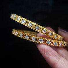 "* Handcrafted Gold Plated Bangle Set * High Quality 22 K Gold Plated 2 pc bangle set; * Available Sizes: 2.4 ( 2.30\" diameter of the inner circle) ; 2.6 ( 2.43\" inner circle diameter); 2.8 (2.54\" diameter of the inner circle) * Sold as a set of 2 bangles The gorgeous gold-plated bangle/ bracelet best exemplifies the careful craftsmanship done on it -- a specialty at Nemali Jewelry. It has a special tone of elegance attached to it. The intricate handmade design of the bangle/bracelet set give White Bangle Jewelry For Marriage, White Bangle For Marriage, Stackable Bangle Jewelry For Wedding, Stackable Wedding Bangle Jewelry, Hoop Bangle For Wedding, Dazzling Round Bangle For Festive Occasions, Dazzling Round Bangle As A Gift, Dazzling Round Bangle Gift, Stackable Cubic Zirconia Wedding Bangle