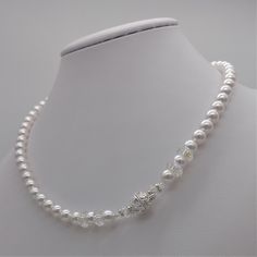 This beautiful choker necklace is handmade with 6mm white Swarovski pearls. It's adorned with 8mm Swarovski rondelle detailing and a magnetic closure with crystals that make it particularly sumptuous. It's a classic necklace that never goes out of style. A luxurious accessory for an elegant occasion. The necklace will be delivered in its case, ready to be gifted. Matching earrings and a bracelet are available. For ideas or alternatives, feel free to contact me. Classic White Crystal Necklace, Classic White Crystal Bridal Necklace, Diamond White Single Strand Necklace For Gift, Adjustable Pearl White Bridal Necklace For Formal Occasions, White Single Strand Necklace For Wedding, Formal Adjustable Pearl White Bridal Necklace, Adjustable Single Strand Pearl Necklace For Wedding, Crystal Beaded Necklaces With Pearl Chain For Gifts, Gift Crystal Beaded Necklace With Pearl Chain