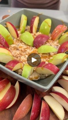 an apple and oatmeal dish is displayed on a cutting board with sliced apples