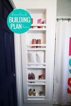 a bathroom with white shelving next to a shower curtain and toilet paper roll holder