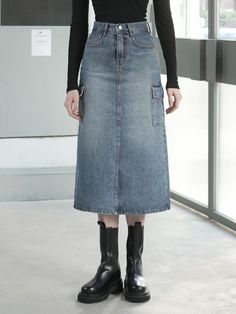 The item pictured is a denim skirt with a midi length and an A-line silhouette. The skirt features utility elements such as large patch pockets on the sides, which add to its practicality. It is designed with a high-waisted fit, judging from the length of the fly and the placement of the waistband. The construction includes a front closure likely consisting of a zipper and button, and the piece shows contrast stitching, which is characteristic of denim clothing.- The side patch pockets are both a functional and stylistic element, emphasizing the skirt's utilitarian design.- The A-line shape offers a flattering fit that may suit a variety of body types, providing comfort and ease of movement.- The midi length and high waist are classic elements that contribute to a timeless appearance, maki Fall Denim Knee-length Skirt, Fall Knee-length Denim Skirt, Medium Wash Knee-length Denim Skirt For Fall, Medium Wash Knee-length Skirt For Fall, Fall Denim Midi Skirt With Pockets, Fall Midi Denim Skirt With Pockets, Knee-length Medium Wash Skirt For Fall, Denim Blue Skirt With Pockets For Fall, Fall Denim Blue Skirt With Pockets