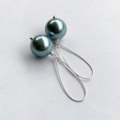 These light blue pearl earrings are perfect for date night or a wedding!  Silver plated kidney ear wires featuring chunky 20mm round metallic light blue faux pearls and measuring 3 inches in total earring length.  A beautiful sheen and unique color!  Lightweight too :) Item is carefully packaged and shipped via USPS in a sturdy protective mailer. Check out more fabulous jewelry and enter my shop here: https://www.etsy.com/shop/jewelbytessyla View the positive feedback I've received from customer Blue Teardrop Pearl Drop Earrings, Formal Blue Pearl Earrings, Blue Dangle Pearl Drop Earrings, Blue Pearl Drop Dangle Earrings, Blue Pearl Drop Earrings For Party, Blue Pearl Dangle Earrings, Pearl Earrings Long, Blue Pearl Earrings, Pearl Dangle Earrings