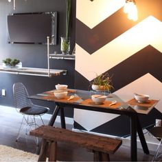 a dining room table with two chairs and a bench