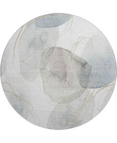 a round rug with an abstract design in grey and gold on the bottom, along with white background