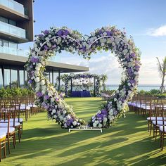 a heart - shaped arrangement of flowers is arranged on the lawn for an outdoor ceremony