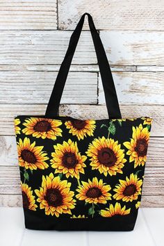 Sunflower with Black Trim Tote Bag Perfect size tote for the beach,daytrips, or for everyday!  Canvas Construction Zip Top Closure Attached 5.5" Wide x 4.25" Tall Zip Top Pouch Two Webbed Handles with 9.5" Drop 13" Wide (Bottom) x 17" Wide (Top) x 14" Tall x 4.5" Deep Pick Up Available in Itasca, Texas Black Beach Bag For Spring Travel, Summer Style Black Beach Bag For Spring, Large Capacity Black Beach Bag For Spring, Summer Large Capacity Black Canvas Bag, Black Canvas Bag With Large Capacity For Summer, Black Large Capacity Canvas Bag For Summer, Black Canvas Bag For Summer Vacation, Black Beach Bag For Daily Use In Spring, Spring Black Beach Bag For Daily Use