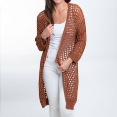 Beat the chill in style with the Enya Long Crochet Cardigan. Featuring a trendy neutral sepia tone with an open crochet detail, this cardigan is easy to wear and certain to become your spring go-to. This long sleeve sweater is perfect for your Spring and Summer wardrobe, throw over your favorite top with a pair of leggings or skinny jeans with some sandals and necklace for a classic look! This top is a light weight sweater, it will give you enough warmth and comfort in a cool day without looking Cozy Open Knit Beach Sweater, Beach Sweater With Open Knit, Beach Knit Cardigan For Fall, Fall Beach Knit Cardigan, Knit Open Front Outerwear For Beach, Open Front Knit Outerwear For Beach, Open Front Knit Outerwear For The Beach, Lightweight Cardigan For Beach In Fall, Cozy Beach Cardigan