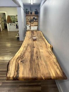 a long wooden table sitting in the middle of a hallway