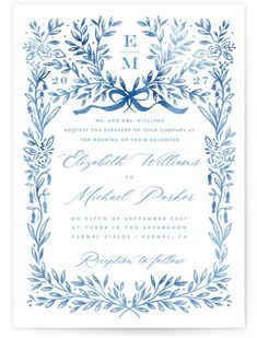 a blue and white wedding card with an elegant floral design on the front, in watercolor