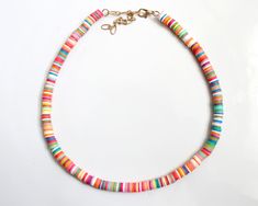 "more cute and fun necklaces and earrings in DearDanielleJewelry: https://www.etsy.com/shop/DearDanielleJewelry?ref=seller-platform-mcnav§ion_id=28417638 surfer heishi choker necklace. rainbow heishi beads necklace(necklace only). rubber beads necklace. cute surfer necklace. please choose your color: white, rainbow, pink, turquoise, black adjustable necklace length: 15-17\" Bead size: 1/4\" diameter **framed gems and charms are gold plated which means you can have beautiful and trendy jewelries Fun Round Heishi Beads Jewelry, Colorful Heishi Bead Jewelry For Fun, Fun Colorful Heishi Beads Jewelry, Colorful Heishi Beads Jewelry, Cute Rainbow Jewelry For The Beach, Cute Rainbow Jewelry For Beach, Colorful Heishi Beads Jewelry For The Beach, Beach Fun Jewelry With Heishi Beads, Fun Necklaces