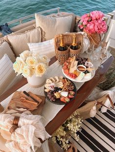 a table filled with food and drinks on top of a boat