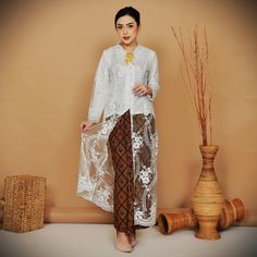 long  beautiful tulle  white kebaya wedding , this kebaya material is tulle, with lining hyget, you can wear it in spring, winter, summer, and autumn, and it is comfortable for Muslim brides, we have some sizes for you, S, M, L, Xl, 2L, 3L, 4L, 5L but   we need your body measurement to make it fit for you, this item  is ready stock, but if you need a bigger size or smaller size that don't list yet, please contact us we can create it pre-order for you   Material: tulle hyget button size: S, M, L, XL, 2L,3L, 4L, 5L we need your body measurement: bust circumference:   waist circumference: hip circumference: please in centimeter you can choose kebaya only or set with a sarong skirt  we will choose the sarong skirt pattern(batik  classic  gold wiru for weddings) White Lace Formal Sets, Traditional White Ao Dai For Formal Occasions, Traditional White Ao Dai For Party, Traditional White Ao Dai For Wedding, Long Sleeve Lace Sets For Wedding, Lace Wedding Sets With Long Sleeves, Traditional Lace Sets For Ceremonies, Traditional White Lace Sets, Traditional Lace Ceremony Set