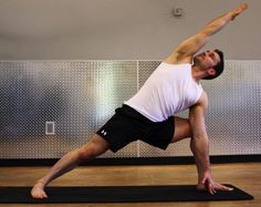 a man is doing yoga on a mat