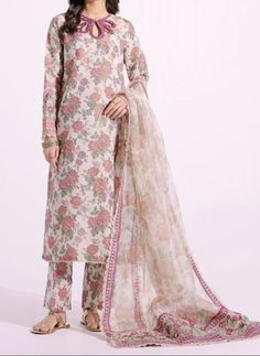 Material: High-quality filament Zari fabric this three-piece outfit, you'll find a modern shirt adorned with intricate embroidery on a powder coral floral print canvas. It's perfectly matched with straight trouser in the same print, and the ensemble is elegantly completed with a traditionally draped printed dupatta, featuring an embroidered border for added charm. Color. beige  Occasion: Ideal for weddings, parties, or cultural events Ready to wear, no hassle of stitching Comfortable and easy to move in Exquisite craftsmanship Care Instructions: Dry clean only for long-lasting beauty and durability.  the color of the product in the photo might look slightly different in person due to factors like lighting and screen settings." Elegant Georgette Sharara With Printed Motifs, Elegant Palazzo Set With Printed Motifs For Designer Wear, Elegant Semi-stitched Lawn Suit With Floral Embroidery, Elegant Sets With Printed Motifs For Eid, Unstitched Embroidered Georgette Palazzo Set, Elegant Unstitched Suit With Floral Embroidery For Eid, Elegant Floral Embroidered Unstitched Suit For Eid, Transitional Silk Lawn Suit With Dupatta, Unstitched Silk Lawn Suit For Transitional Season