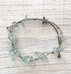 Gorgeous beach bracelet or anklet made with light mint green sea glass pebbles on our durable hand spun rope cord. Pure island style! Easy and secure adjustable slide knot closure allows for easy on and off. This bracelet/anklet is completely waterproof and metal free making it perfect for anyone with skin sensitivities and is a wonderful and unique gift for those hard to shop for friends and family on your list, especially the beach lovers! Color: Mint Green Size: Available in three sizes. Brac Handmade Adjustable Coastal Beaded Bracelets, Green Beaded Bracelets With Adjustable Cord For Beach, Handmade Adjustable Sea Glass Bracelets, Green Adjustable Cord Beach Bracelet, Green Adjustable Cord Bracelets For Beach, Resizable Braided Bracelets With Waxed Cord For Beach, Hand-strung Waxed Cord Beach Bracelets, Adjustable Recycled Glass Bracelets As Gift, Hand-strung Waxed Cord Bracelets For Beach