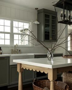 a kitchen with an island in the middle and a basket on the counter top next to it