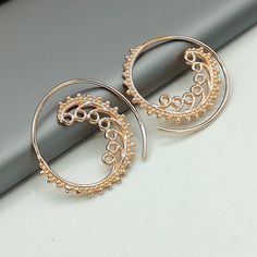 Indian style sterling silver spiral ear hoops. These are dipped in rose gold. Dimensions: 25 mm x 26 mm Price listed is for a pair. These earrings are made of 925 hypoallergenic sterling silver and rose gold All my pieces are sent in a gift box. I can include a personal message from you if needed. You are welcome to contact me at... bhavnakwintra1956@gmail.com More hoops: https://www.etsy.com/your/shops/TheSilverGame/tools/listings/section:26305414 More earrings: https://www.etsy.com/your/shops/ Elegant Silver Hoop Earrings In Copper, Elegant Silver Hoop Earrings With Copper, Nickel Free Rose Gold Circle Earrings, Elegant Silver-colored Copper Hoop Earrings, Nickel-free Rose Gold Circle Earrings, Rose Gold Metal Hoop Earrings For Pierced Ears, Rose Gold Wire Wrapped Hoop Earrings, Bohemian Rose Gold Jewelry With Ear Wire, Dainty Rose Gold Hoop Earrings For Pierced Ears