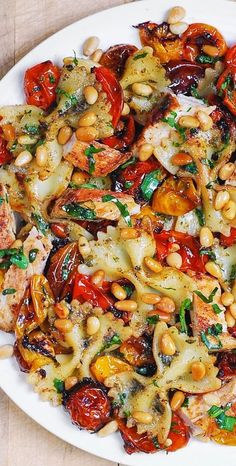 a white plate topped with pasta and vegetables