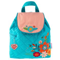 a blue backpack with flowers and hearts on the front, sitting against a white background