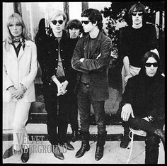 an old black and white photo of the rolling stones posing for a group shot in front of a building