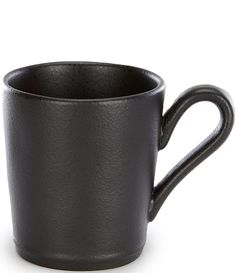 a black coffee cup sitting on top of a white table