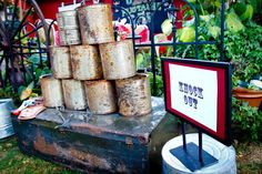 there are many tins stacked on top of each other in this yard sale display