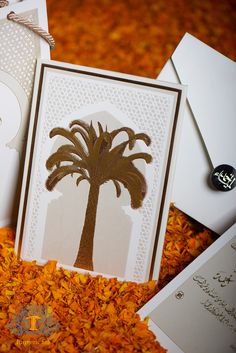 two greeting cards, one with a palm tree on it and the other with an envelope