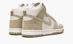 The Nike Dunk High Premium “Tan Suede” is a versatile colorway of the vintage basketball shoe with a two-tone, white-and-tan appearance.  Ideal for casual, everyday wear, the “Tan Suede” can be paired with virtually anything in a wardrobe, making it a foundational shoe of a sneaker collection.  The perforated toe, mid-panel, collar, and heel are designed in white leather while the overlays and Swoosh are featured in tan suede.  The tan nylon tongue tag is complete with white “Nike” branding.  Th Tan Suede Shoes, Nike Branding, Vintage Basketball, Nike Dunk High, Dunk High, Nike Brand, White Nike, Perforated Leather, Tan Suede