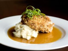 a white plate topped with mashed potatoes and gravy