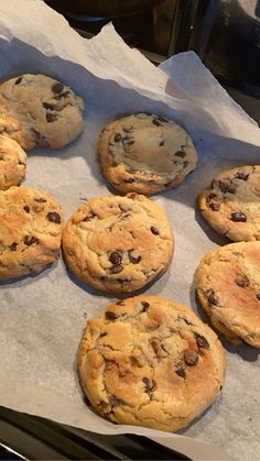 chocolate chip cookies sitting on top of parchment paper