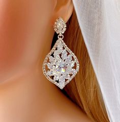 a close up view of a pair of earrings on a mannequin's head