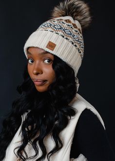 Patterned perfection with our newest pom hat collection! Grab the matching mittens for a complete look that will keep you warm, yet fashionable throughout the colder months ahead.  Cream, black, camel and white patterned knit pom hat Cuff detail at the hemline Natural faux fur pom accent Fleece lined Crown patch on the left side One size Designed in the U.S.A. Produced in China. 100% Acrylic Matching mittens available Cream Hats For Cold Weather In Fall, Cozy Beige Bonnet For Cold Weather, Cream Beanie Hat For Fall, Cream Beanie For Fall, Cozy Beige Hats For Cold Weather, Cozy Beige Hat For Outdoor, Cream Hats For Outdoor Fall Events, Cream Hat For Fall Outdoor Events, Cream Hat For Outdoor Fall Events