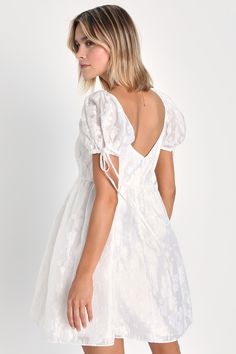 If sweetness is your middle name, you'll find your perfect match in the Lulus Exceptionally Angelic White Floral Puff Sleeve Mini Dress! Airy woven fabric, with a subtle sheen and darling floral appliques throughout, shapes this adorable dress. Short puff sleeves (with elastic at the shoulders and drawstring cuffs) frame a bodice with a cutout detail and a tie accenting the scoop neckline. Babydoll-style silhouette continues down to a mini hem. Hidden zipper/clasp at back. Fit: This garment fits Spring Mini Dress With Sweetheart Neckline And Gathered Sleeves, Summer Mini Dress With Gathered Sleeves And Sweetheart Neckline, Summer Mini Dress With Sweetheart Neckline And Gathered Sleeves, White Puff Sleeve Dress With Tie Back For Brunch, Spring Day Out Puff Sleeve Dress With Sweetheart Neckline, Elegant Puff Sleeve Mini Dress With Smocked Back, White Puff Sleeve Dress With Tie Back, Elegant Mini Dress With Puff Sleeves And Smocked Back, Spring Brunch Puff Sleeve Dress With Sweetheart Neckline