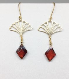 "Lovely gold Vermeil earrings with red Cubic Zirconia (CZ). These earrings evoke the romantic style of a bygone era known as the 1920's where Art Deco design was all the rage! The Vermeil fan shape is both feminine and stylish with a clear red CZ gemstone that is faceted and cut into a diamond shape that enhances its pure red color! Simply stunning, you will not go unnoticed while wearing these beauties. Perfect for your next holiday event or any other occasion. These earrings are light weight a Elegant Christmas Drop Earrings, Classic Brass Jewelry For Party, Gold Art Nouveau Pierced Earrings, Red Chandelier Earrings As Gift, Art Nouveau Gold Pierced Earrings, Elegant Christmas Jewelry With Dangle Shape, Elegant Christmas Jewelry With Matching Earrings, Elegant Round Christmas Earrings, Elegant Christmas Celebration Earrings